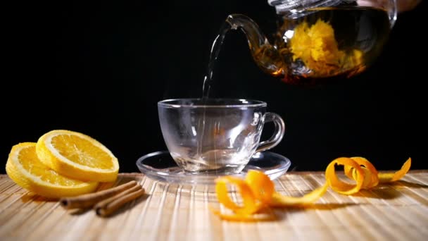 Pouring Blooming Tea with Cinnamon and Orange — Stock Video