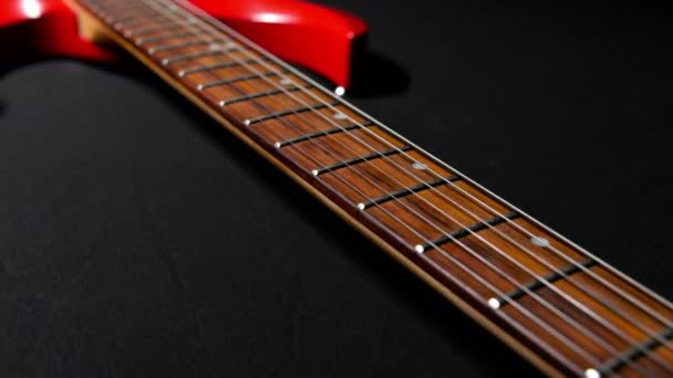 Red Guitar on a Black Background — Stock Video