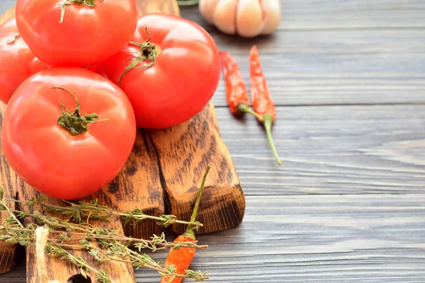 Baharat ile ahşap bir tahta üzerinde kırmızı domates