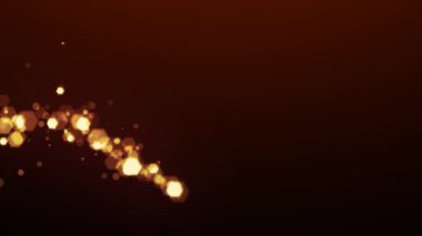 Yeni yıl, Noel ya da tatil partisi tasarımı için karanlık bir arka planda ışıldayan parçacıkların parıldadığı altın parıltı izi. 4K döngü canlandırması.