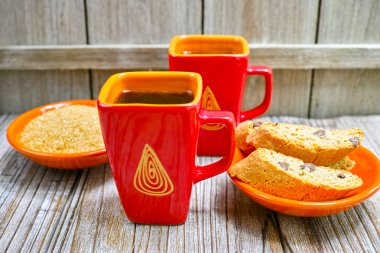 Two cups with espresso coffee, raw brown sugar and amandel cantu