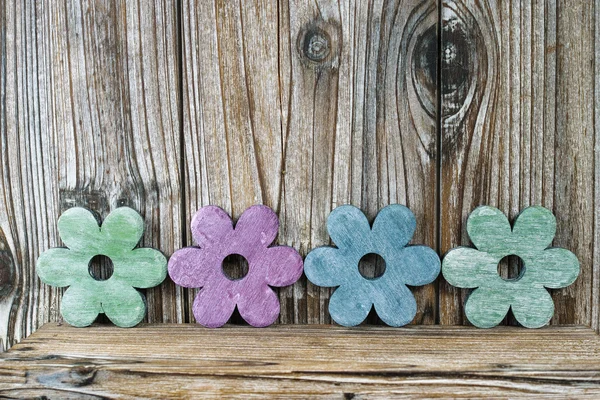 Colorful wooden flowers on wooden background, decoration — Stock Photo, Image