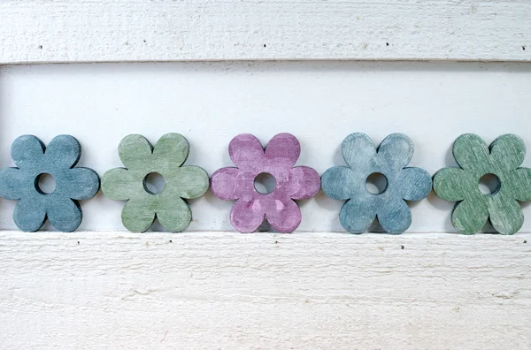Colorful wooden flowers on wooden background — Stock Photo, Image