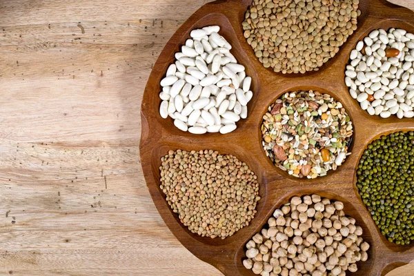 Wooden bowl of various legumes on wooden background copy space — Φωτογραφία Αρχείου