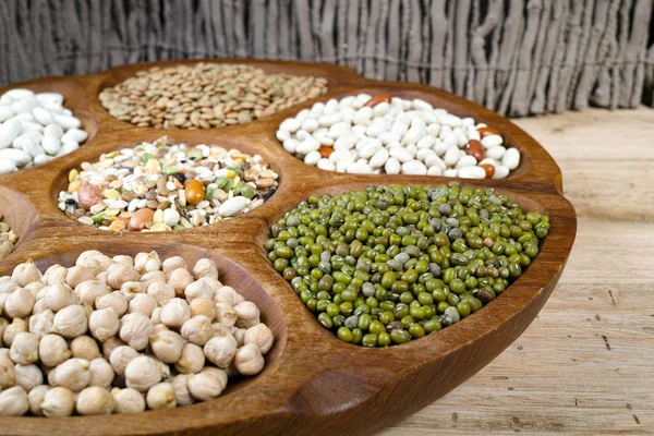 Wooden bowl of various legumes on wooden background copy space — Φωτογραφία Αρχείου