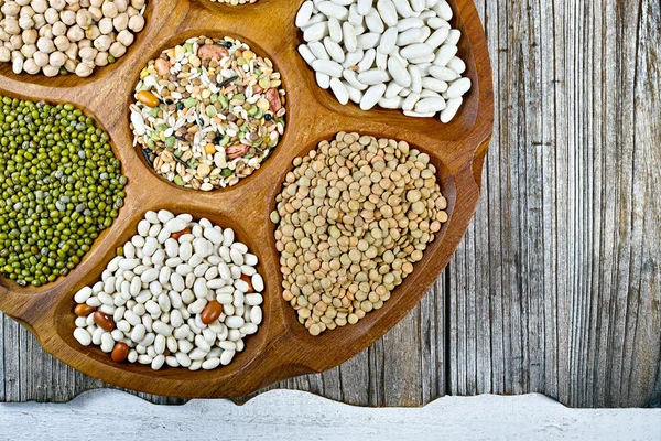 Wooden bowl of various legumes on wooden background copy space — Φωτογραφία Αρχείου