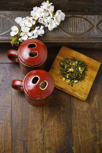 Japan\'s tea cups with green tea and sakura flowers