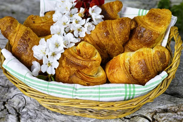 Fresh croissants in a basket from bakery