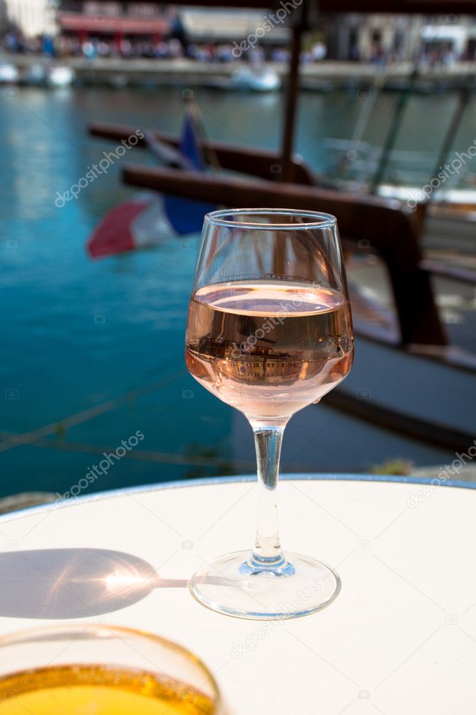 Glass with rose vine  in old French fisherman village, Normandy