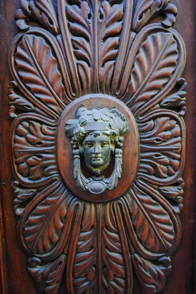 Old ancient door knocker on wooden door — Stock Photo, Image