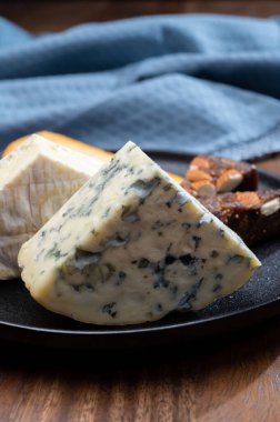 Peynir koleksiyonu, küflü peynir, peynirli krema, peynirli tatlı olarak sunulan incirli badem ekmeği.