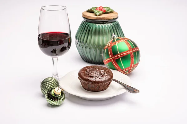 Popular british christmas food, glass of vintage ruby port wine and hot chocolate cake with christmas decoration on background isolated on white