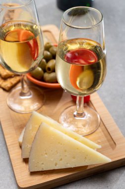 İspanyol tapas, manchego peyniri, yeşil zeytin, peynirli kraker ile servis edilen kuru soğuk fino şeri şarabı.