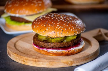 Lezzetli vejetaryen hamburgerlerle öğle veya akşam yemeği ızgara burger, taze fırınlanmış çörek ve organik sebzelerden yapılır.