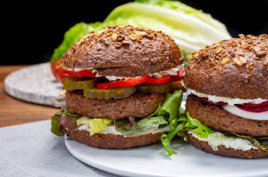 Kızarmış sağlıklı sebzeli vejetaryen hamburgerler, etsiz burgerler ve taze sebzeler.