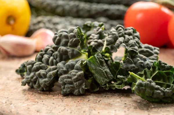 Vegetarian cooking with black flat leaves of cavolo nero tuscan cabbage