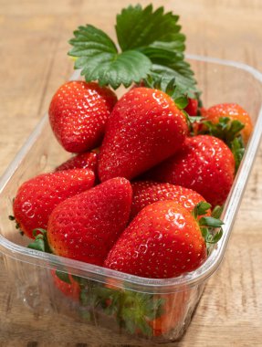 Yeni hasat, bir kutu olgun kırmızı tatlı çilek yakın mesafeden yemeye hazır.