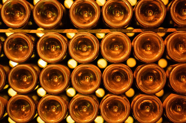 Champagne grand cru sparkling wine production in bottles in rows in dark underground cellars, Reims, Champagne, France
