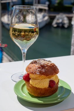 Tarte tropezienne ya da La Tarte de Saint-Tropez. Açık havada servis edilen kremalı ve taze meyveli çöreklerden oluşan tatlı tatlısı. Bir kadeh beyaz şarapla.