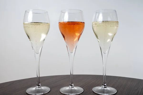 白と黒の試飲フルートグラスからシャンパン輝くワインをバラ — ストック写真