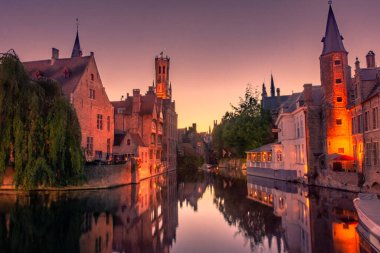 BRUGES, BELGIUM, 21 HAZİRAN 2020: Tarihi merkezdeki kanal üzerinde gün batımı