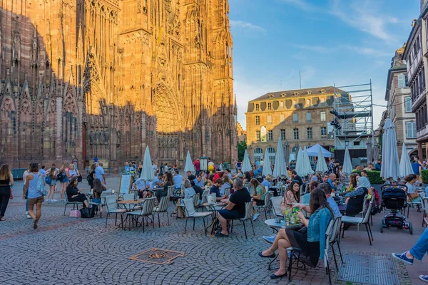 STRASBOURG, FRANCE, 18 JULY 2020: People eating in the restaurant in front of the cathedral