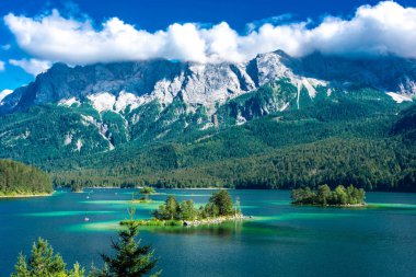 Faboulus landscape of Eibsee Lake with turquoise water in front of Zugspitze summit under sunlight. Location: Eibsee lake, Garmisch-Partenkirchen, Bavarian alps, Germany, Europe clipart