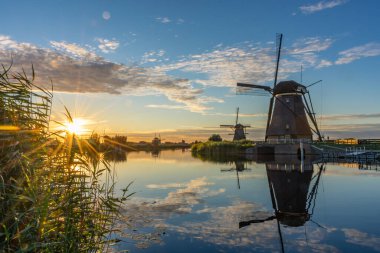 Hollanda 'daki Kinderdijk' in yel değirmenleri üzerinde inanılmaz bir gün batımı.
