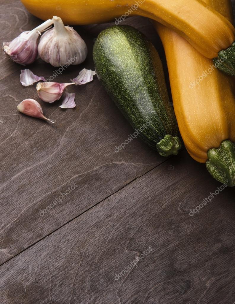 Two yellow big and medium small green zucchini on wooden table ... Two yellow big and medium small green zucchini on wooden table ...