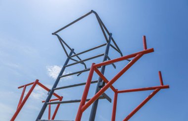Participants are actively training on horizontal bars in a fitness park, enjoying the sunny weather and engaging in physical activity.