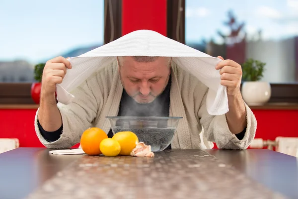 Mature man with colds and flu. Inhalation of herbs — Stock Photo, Image