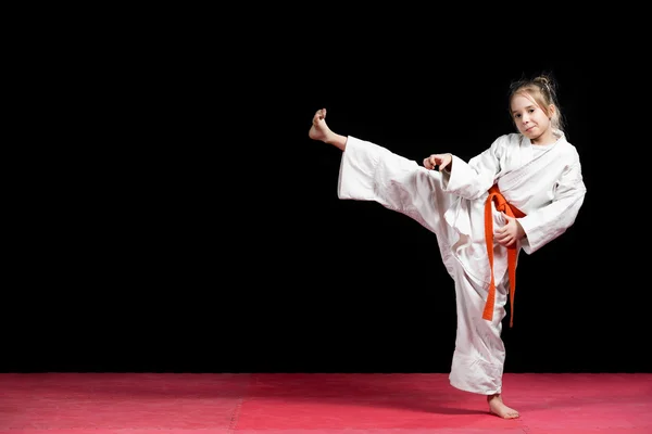 Little girl practice karate isolated on black — Stock Photo, Image