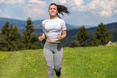 Çayırda spor yapan atletik bir kadın. Bir dizi fotoğraftan..