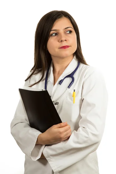 Portrait of young confident female doctor holding folder — Stockfoto