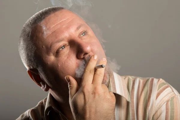 Close-up of man face holding cigarette and smoking — Stock Photo, Image