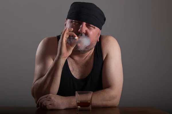 Homem adulto fuma cigarro e bebe uísque — Fotografia de Stock