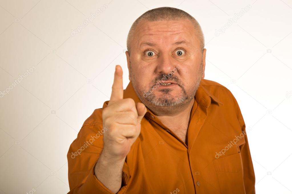 An angry man with beard pointing finger at you