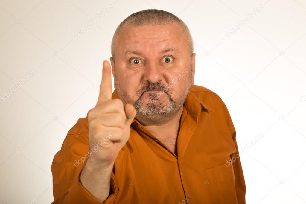 An angry man with beard pointing finger at you