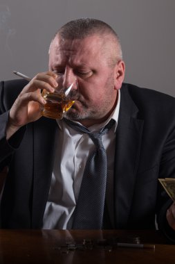 Bir bardak viski ve sigara ile iş adamı kırdı