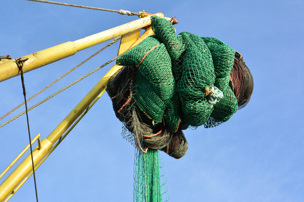 Fishing nets on a trawler against blue sky