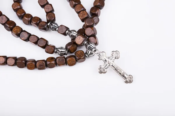 Rosary with a cross on a white background — Stock Photo, Image