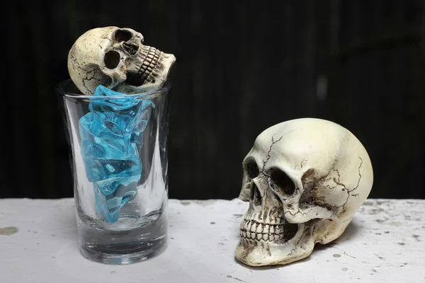 skull with Blue Ice in shot glass. -still life