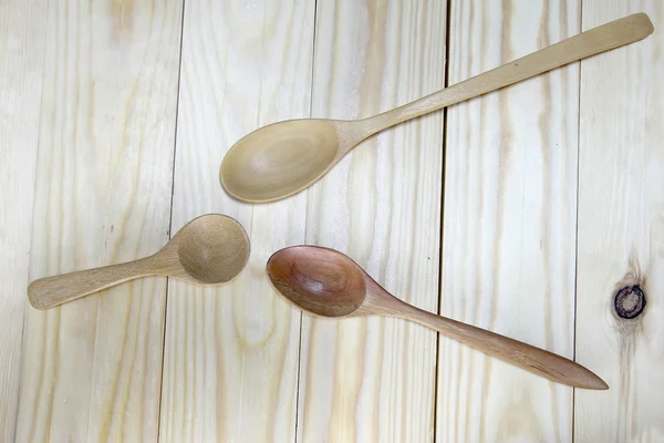 Wood spoons on wooden table. Kitchen utensils.