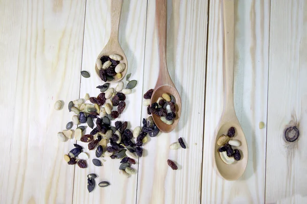 ahşap arka plan ağaç kaşık ile organik karışık Kuruyemiş