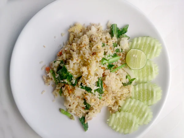 Thai fried rice with pork on white dish have lemon and Chilli fish sauce for flavour