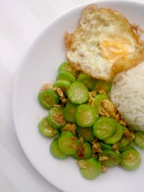 Beyaz arka plan ile beyaz çanak üzerinde kızarmış kabak pilav ile yumurta ile karıştırın. Vejetaryen gıda ve sağlıklı gıda.