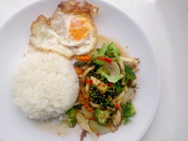 Tavada kızartılmış yemeğimi renkli sebze ve Tayland pirinç yasemin ve beyaz tabak kızarmış yumurta beyaz arka plan üzerinde izole et. Vejetaryen yiyecekler, sağlıklı gıda.