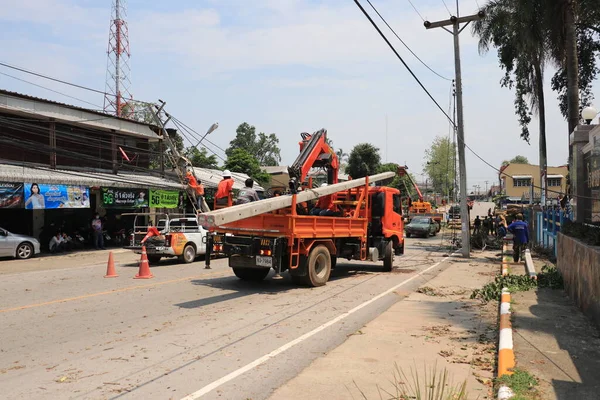 Lampang, Thailand, 21 May 2021 : The staff are cleaning the streets. A big tree fallen on the road in Luang Nuea Subdistrict,  Banmai Phahonyothin Banmai Road in front of Anubanngao (Panunuyom) School