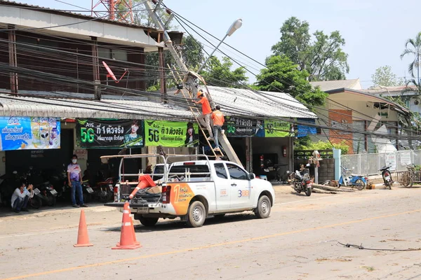 Lampang, Thailand, 21 May 2021 : The staff are cleaning the streets. A big tree fallen on the road in Luang Nuea Subdistrict,  Banmai Phahonyothin Banmai Road in front of Anubanngao (Panunuyom) School