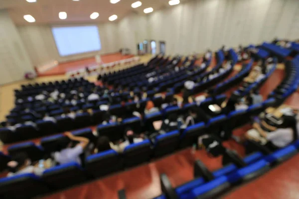Blurred  of students, audience keynote speaker, people meeting start up business program collaboration discussion and listen in convention hall. event university or campus.